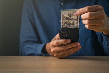 Global Economic and exchange rate on currency stock market. business man holding banknote and using phone  for US dollar index concept.