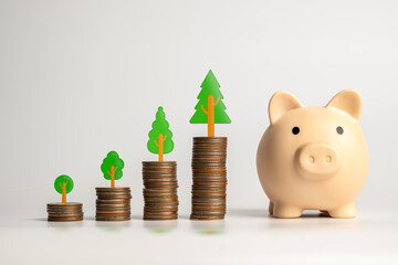 A visual metaphor for financial growth featuring coin stacks and a piggy bank with tree symbolizing...