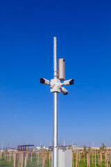 Security video cameras on a pole on blue sky background