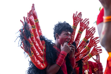 Kulasai Dasara, Portrait of indian devotee with painted face and dressed as hindu god kali to...