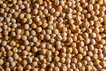 Uncooked Yellow Polished Peas Background. A Culinary Canvas of Dry Yellow Peas, Creating a Lively and Textured Background for Gourmet Cooking. Scattered Raw Polished Peas. Healthy Eating Ingredients
