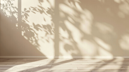 Obraz premium Soft tree branch shadows on beige wall in sunlit space. Empty copy space