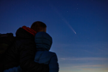 Father and son watching the comet C/2023 A3 Tsuchinshan-ATLAS pass over the sky in Poland.