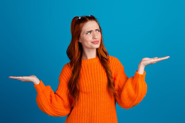 Photo of attractive young woman look skeptical hold compare empty space dressed stylish knitted...