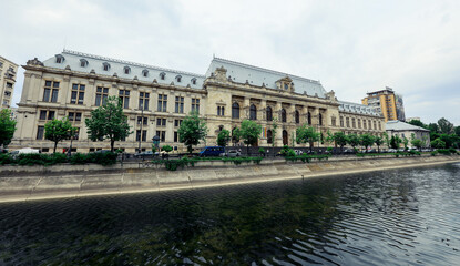 Fototapeta premium Historic architecture along a river in Bucharest Romania reflects the city’s cultural heritage