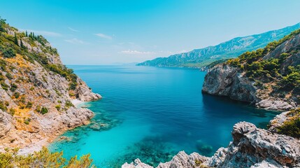 Fototapeta premium Undiscovered coastal cove surrounded by jagged cliffs and crystal blue water, untouched wilderness, perfect isolation, hidden coastline, wild solitude