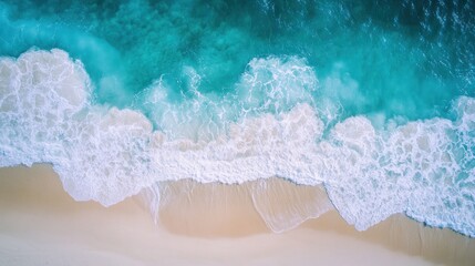 Obraz premium Aerial View of Turquoise Ocean Waves Crashing on White Sandy Beach