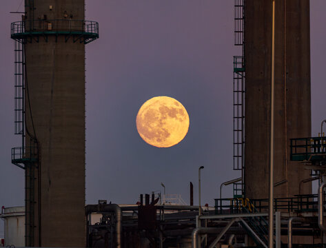 Full moon rising over industrial Porto landscape