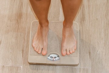 Checking weight on a bathroom scale from a bird's-eye view