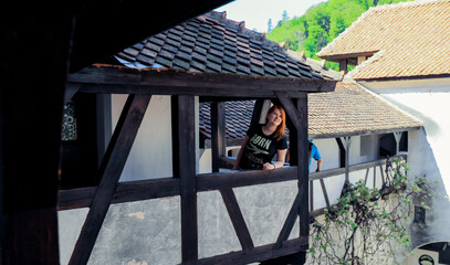 Tourist relaxing on a balcony of a historic building in Romania during a sunny day © Dave