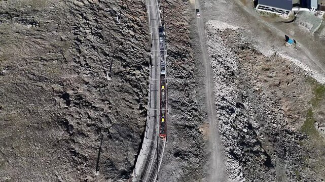Top-down aerial shot of Gornergrat train in Pennine Alps, Switzerland