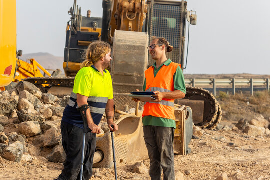Disabled inspector discussing with colleague at construction site