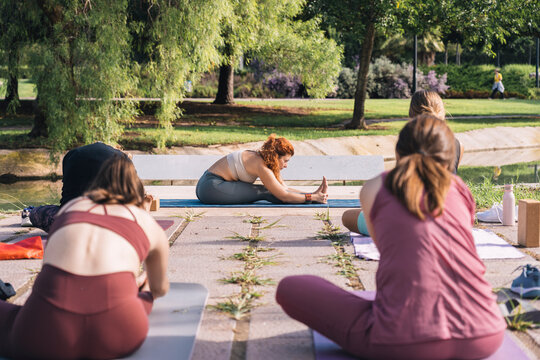 Outdoor yoga class with diverse participants and instructor