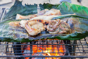 Grilling pork and intestines with banana leaves bottom in the countryside