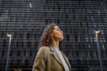 Brazilian businesswoman in urban setting looks confidently ahead
