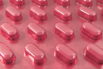 Tablets in red blister pack background