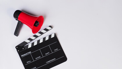 Clapper board and red megaphone on white background.