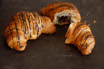 Croissant with butter two pieces on a black board. High quality photo