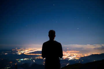 Fototapeta premium silhouette of person standing on top of the mountain