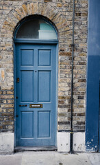 Old blue door with Brown brick