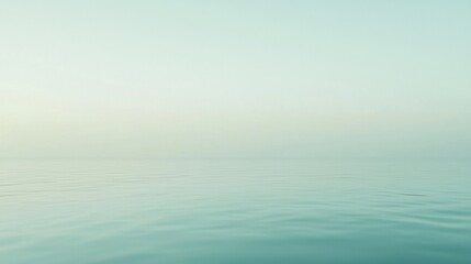 Obraz premium Tranquil ocean merging with pastel sky at sunset, evoking relaxation and mindfulness. Soft focus adds ethereal quality to idyllic seascape