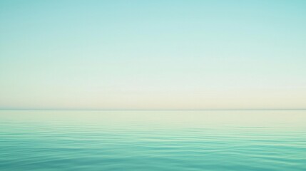 Obraz premium The calm ocean under a pastel sky creates a peaceful scene, perfect for relaxation and mindfulness. Ideal for summer themes, the image invites viewers to unwind by the sea