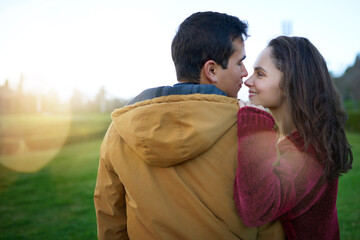 Fototapeta premium Couple, happy and romance in nature for travel, relationship and holiday with smile, embrace and support. People, connection and love outdoor for date, bonding and relax on weekend with vacation