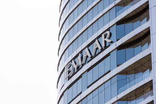 Close-up of the Emaar logo on a modern glass building.