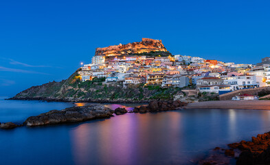 Beautiful panoramic view of medieval town of Castelsardo at evening (night), during the blue hour, Province of Sassari, Sardinia, Italy, Europe.