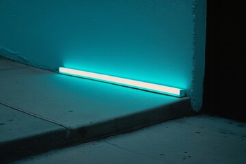 Close-up of a sleek, modern blue neon light at night casting a serene glow on a minimalist urban sidewalk.