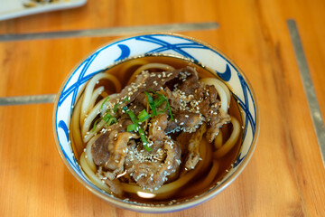 Japanese Cuisine hot soup udon noodle as kake udon with a mild broth called kakejiru made from...