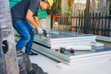 Engineer working at prefabricated wall production factory.

