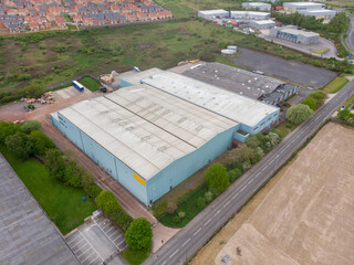 Aerial drone photo of a large abandoned warehouse or factory building located in the town of Wakefield in West Yorkshire in the UK showing the large building and sorounding roads