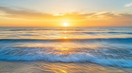 Fototapeta premium Calm ocean waves under a golden sunset, abstract horizon line with a spacious sky for text