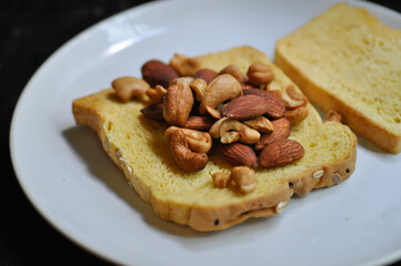 bread , pumpkin bread or sliced bread or a piece of bread with almond and cashew nut topping