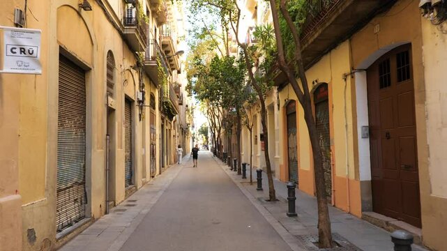 Walking down a street in Barcelona in the neighborhood of Gracia, Catalonia, Spain.  Moving shot.