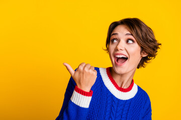 Full length photo of lovely young lady point excited empty space dressed stylish blue knitted...