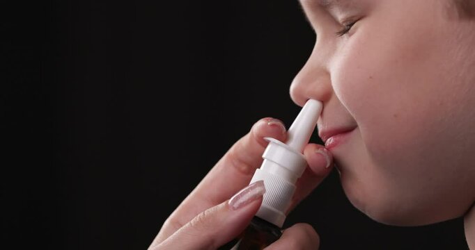 Person Holds in Hand Aerosol Bottle with Pharmaceutical Preparation, Spraying in Nose Child Nasal Spray from Cold, Virus, Flu, Runny Nose. Seasonal Disease in Childhood and their Systematic Treatment.