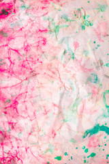 Abstract artist's drawing with watercolor paints with many colors, on crumpled wet paper. Background with unusual patterns for your creative work or design.