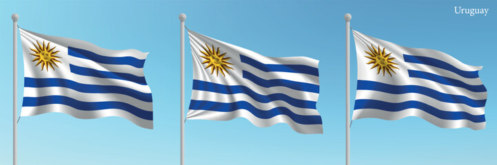 Obraz premium Set of three flags of Uruguay waving on flagpoles