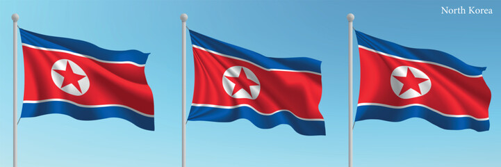 Set of three flags of North Korea waving on flagpoles