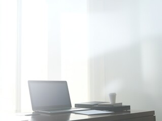 A minimalist workspace with a laptop, printer, and coffee cup illuminated by natural light.