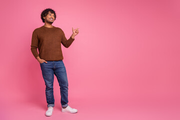 Photo of cheerful funny man wear trendy brown clothes look empty space isolated on pink color background