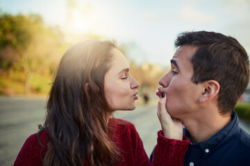 Fototapeta premium Couple, happy and playful outdoor for love, relationship and holiday with funny face, goofy and romance. People, trust and silly together for date, bonding and connection on weekend with vacation