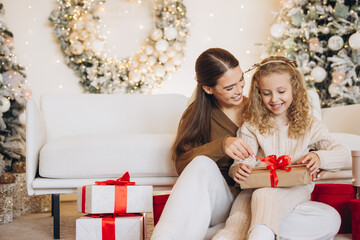 Mother and Daughter Enjoying Christmas Gift Opening Together
