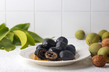 Handmade jam made from green fresh walnuts. Organic walnut jam and walnuts.