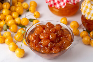 Homemade DIY natural canned yellow cherry plum sauce chutney with chilli or tkemali in glass jar - Cherry jam