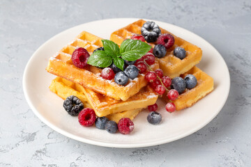 Delicious fresh baked belgian waffles with berries and fruit