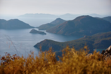 Obraz premium Top view of the islands in the sea during sunset. Mountain peaks on the Lycian Trail in Turkey