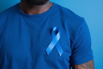 Man wearing t-shirt with blue ribbon symbolizing prostate cancer awareness month